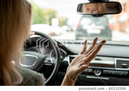 Hand of irritated and tired mature blond businesswoman expressing annoyance 68528506