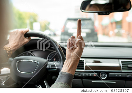 Hand of busy and annoyed mature businesswoman showing rude gesture 68528507