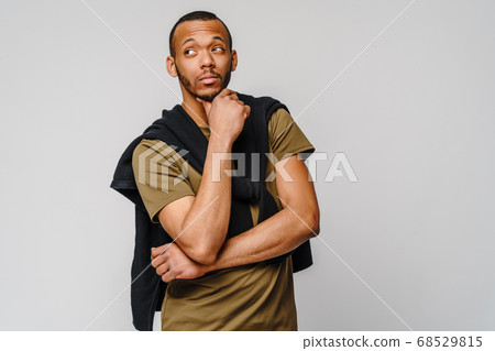 african-american young man in green t-shirt over light grey background with copy space african-american young man in green t-shirt over light grey background with copy space 68529815