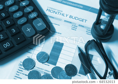 Financial paper and coins and pen and glasses and sand-hour, business concept. Financial paper and coins and pen and glasses and sand-hour, business concept. 68532013