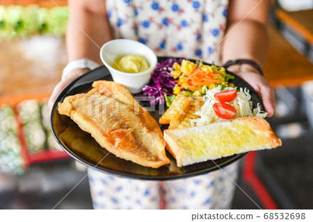 fried fish fillet / steak fish with sauce cream 68532698