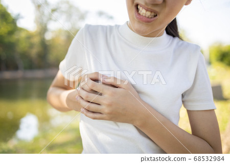 Asian child girl touching her breasts sore with severe pain in her chest,teenage girl feel menstrual breast pain,hormonal or growth in to adolescents cause irritation,painful engorgement to the breast Asian child girl touching her breasts sore with severe pain in her chest,teenage girl feel menstrual breast pain,hormonal or growth in to adolescents cause irritation,painful engorgement to the breast 68532984