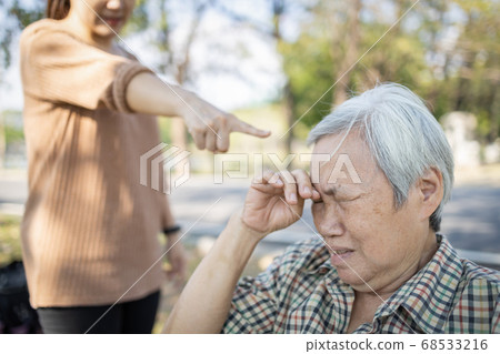 Asian elderly people crying while young caregiver scolding,angry annoyed woman getting mad pointing finger to senior woman, girl yelling,shouting at sad old people,victim of violence and abuse Asian elderly people crying while young caregiver scolding,angry annoyed woman getting mad pointing finger to senior woman, girl yelling,shouting at sad old people,victim of violence and abuse 68533216