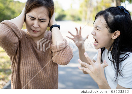 Angry child daughter shouting scolding at her mother about fussy things,nag,aggressive girl screaming,girl is going crazy,losing control of emotions,concept of arguing,relationship,family life problem 68533223