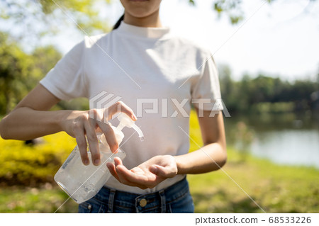 Asian child girl use alcohol antiseptic gel,prevention,cleaning hands frequently,prevent infection of Covid-19 outbreak,woman washing hands with hand sanitizer to avoid contaminated with Corona virus 68533226