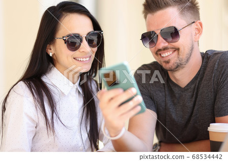 Adult modern fashion people look at smartphone screen portrait. Adult modern fashion people look at smartphone screen portrait. 68534442