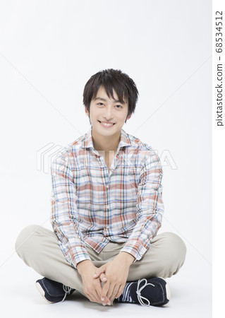 Male college student cross-legged Male college student cross-legged 68534512