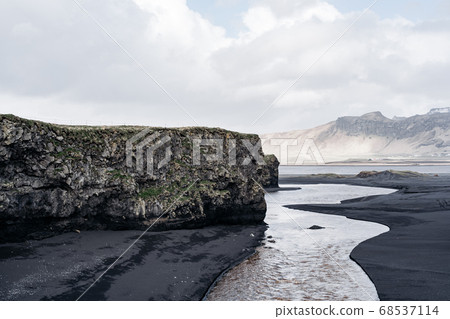 Black sand beach and the basalt mount Reynisfjall, Vik, Iceland. Black sand beach and the basalt mount Reynisfjall, Vik, Iceland. 68537114