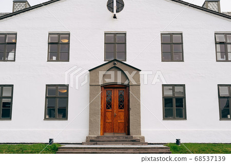 The facade of a white two-story building in Reykjavik, the capital of Iceland. The facade of a white two-story building in Reykjavik, the capital of Iceland. 68537139