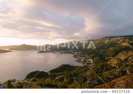 Budvan Coast. Mountains and cities along the road on the Adriatic coast in Montenegro, at sunset. 68537316