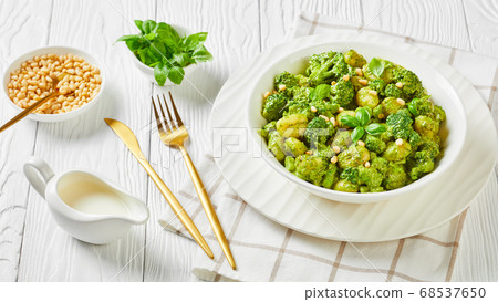 gnocchi with broccoli in a white bowl 68537650