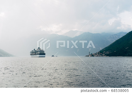 The cruise liner sails near the city of Perast and the islands in Montenegro. 68538005