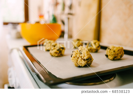 Close-up of the dough balls of raw American cookies on the counter. Close-up of the dough balls of raw American cookies on the counter. 68538123