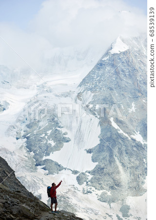 Tourist enjoying mountains scenery. 68539139