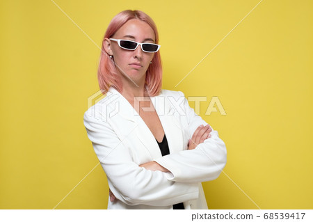 Fashion portrait of serious woman dressed as a secret agent or spy Fashion portrait of serious woman dressed as a secret agent or spy 68539417