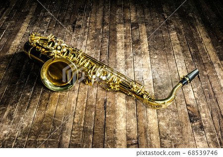 yellow jazz musical instrument saxophone lies on a 68539746