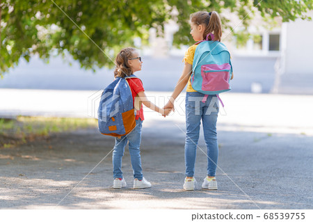 Girls with backpack are going to school 68539755