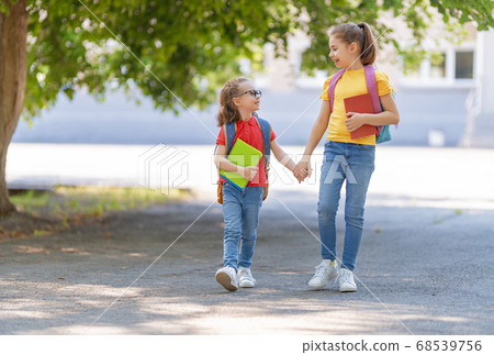 Girls with backpack are going to school 68539756