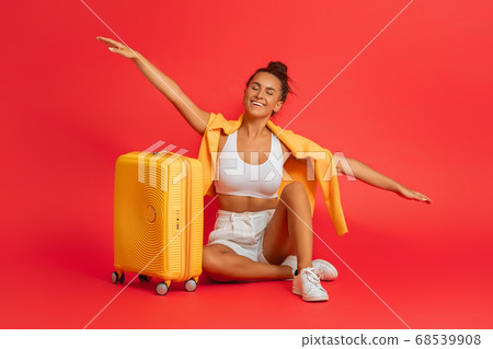 Happy woman going traveling 68539908