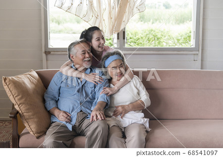 Asian young woman hug and take care senior parent Asian young woman hug and take care senior parent 68541097