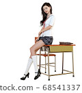 A schoolgirl sitting at a school desk after class and gazing at me while relaxing 68541337