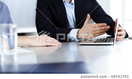 Business people using laptop computer while working together at the desk in modern office. Unknown businessman or male entrepreneur with colleague at workplace. Teamwork and partnership concept 68541701