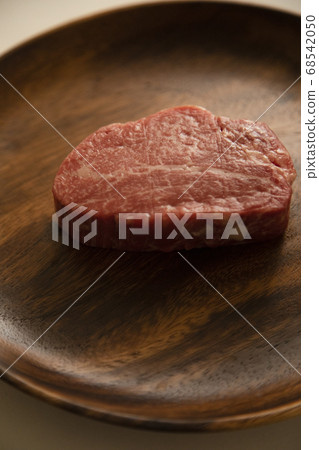 Raw beef fillet steak on acacia plate Raw beef fillet steak on acacia plate 68542050