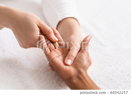 Top view of african woman getting hand massage at spa Top view of african woman getting hand massage at spa 68542257