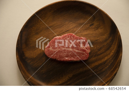 Raw beef fillet steak on acacia plate Raw beef fillet steak on acacia plate 68542654