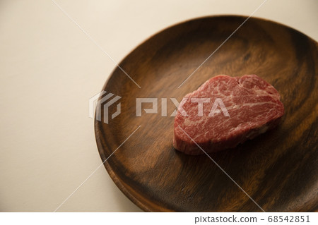 Raw beef fillet steak on acacia plate Raw beef fillet steak on acacia plate 68542851