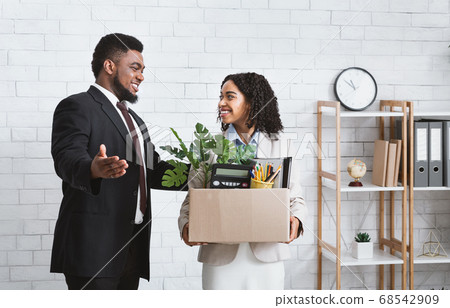 First day at office. African American businessman welcoming new female employee to his team at office First day at office. African American businessman welcoming new female employee to his team at office 68542909