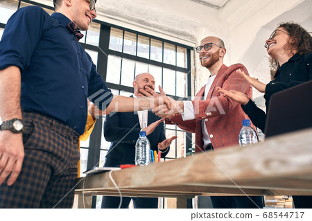Business handshake at meeting or negotiation in the office. Partners are satisfied because signing contract or financial papers. selective focus Business handshake at meeting or negotiation in the office. Partners are satisfied because signing contract or financial papers. selective focus 68544717