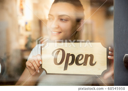 Open sign on the glass of street cafe or restaurant Open sign on the glass of street cafe or restaurant 68545938