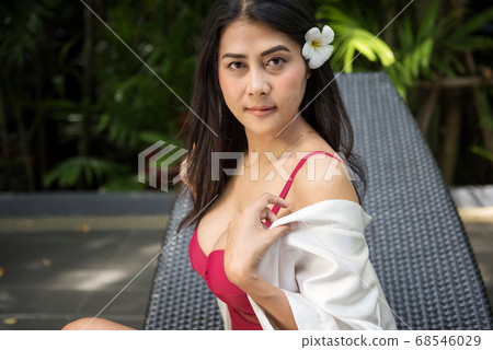 Beauty woman in swimsuit take off bathing gown Beauty woman in swimsuit take off bathing gown 68546029