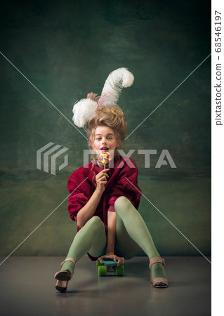Young woman as Marie Antoinette on dark background. Retro style, comparison of eras concept. Young woman as Marie Antoinette on dark background. Retro style, comparison of eras concept. 68546197