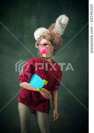 Young woman as Marie Antoinette on dark background. Retro style, comparison of eras concept. Young woman as Marie Antoinette on dark background. Retro style, comparison of eras concept. 68546209