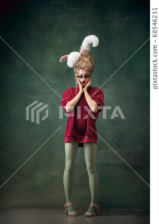 Young woman as Marie Antoinette on dark background. Retro style, comparison of eras concept. 68546231