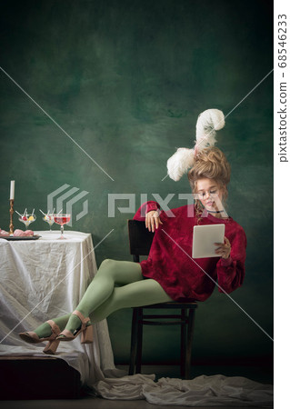 Young woman as Marie Antoinette on dark background. Retro style, comparison of eras concept. 68546233