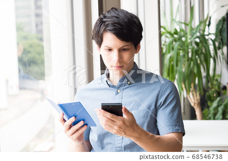 Young men with smartphone and notebook Young men with smartphone and notebook 68546738