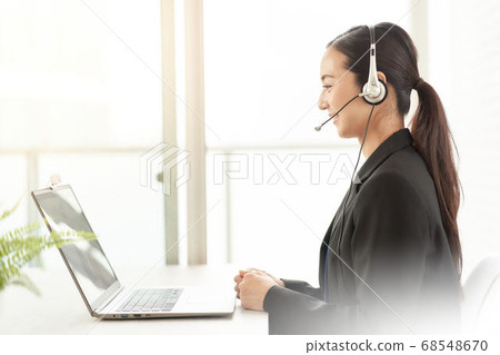 A woman making a video call to the PC 68548670