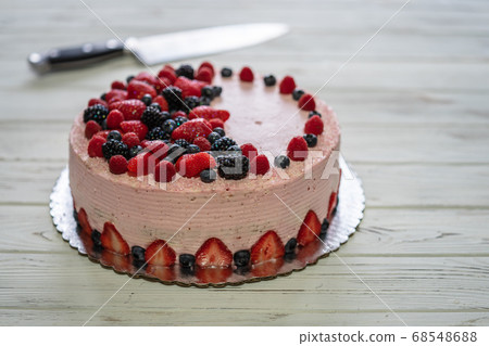 Home made cake with berries. Cake with Strawberry, blackberry, blueberry, and raspberry on a table 68548688