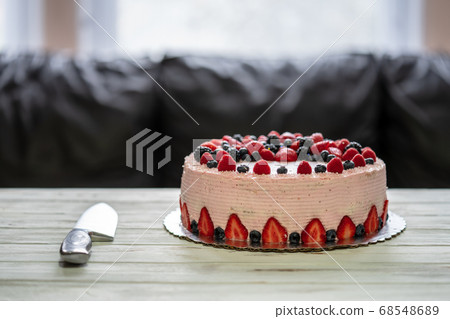 Home made cake with berries. Cake with Strawberry, blackberry, blueberry, and raspberry on a table 68548689