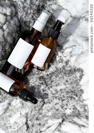Cosmetic bottles on a marble background. 68549389