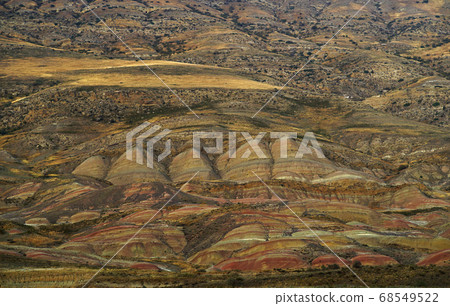 Amazing rocky desert on Georgia Azerbaijan border. Yellow brown red earth rock material covering hills. View from top Amazing rocky desert on Georgia Azerbaijan border. Yellow brown red earth rock material covering hills. View from top 68549522