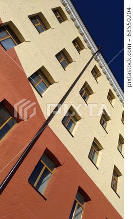 Fragment of brick wall against a blue sky Fragment of brick wall against a blue sky 68550204