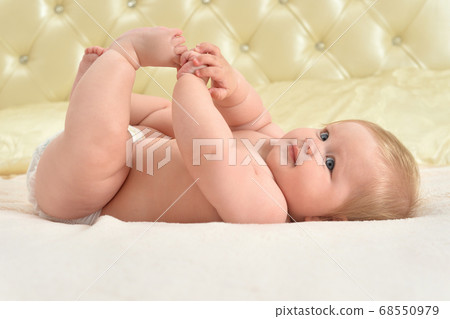 Cute little baby girl on bed smiling 68550979