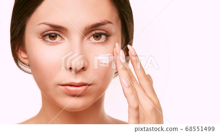 Young woman with white cream. Sun care lotion Young woman with white cream. Sun care lotion 68551499