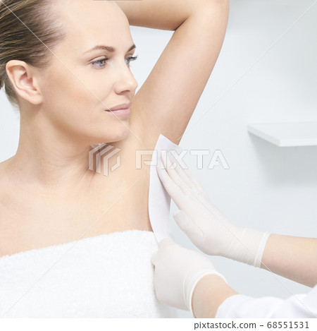 Unwanted hair wax epilation. Young Woman. cosmetology salon treatment procedure. Home waxing 68551531