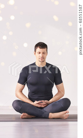 Man sitting at lotus yoga pose. Home morning routine. 68551587