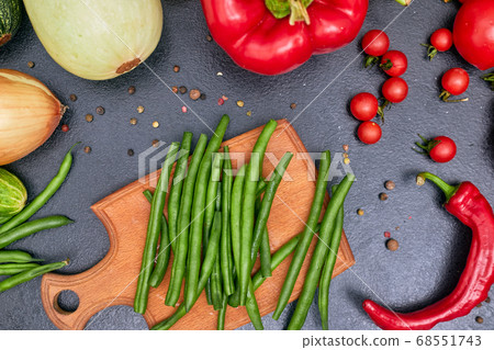chopped green beans on a wood board with vegetables one 68551743